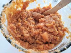 a bowl filled with food and a wooden spoon