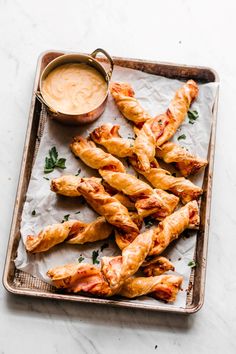 breadsticks on a tray with dipping sauce