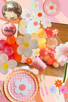 a table topped with lots of balloons and plates