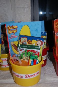 a yellow bucket filled with candy and snacks