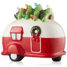 a red and white camper with christmas lights on the roof is shown in front of a white background