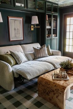 a living room filled with furniture and a chess board on top of a coffee table