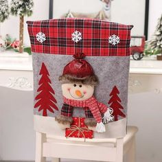 a stuffed snowman sitting on top of a chair