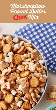 a bowl filled with marshmallow peanut butter chex mix next to a blue and white checkered napkin