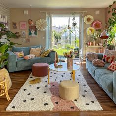 a living room filled with furniture and lots of plants