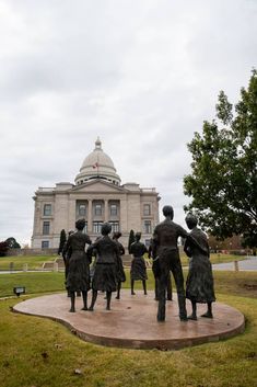 a group of statues in front of a building