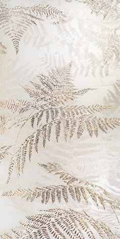 an area rug with leaves on it in white and gold colors, including one large fern