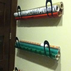 three different colored tubes are hanging on the wall