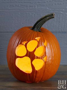 a carved pumpkin with paw prints on it