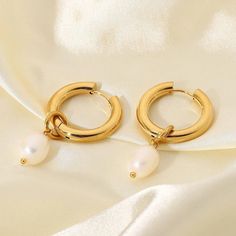 Stay on-trend with these fashionable 18k gold plated stainless steel chunky hoop earrings, accented with the classic beauty of freshwater pearls, making them a perfect blend of contemporary and timeless style. Detachable Freshwater Pearl Pendant so can be worn as just a hoop. 🌟Stainless steel  💛18K PVD gold plated 💦 Fully waterproof 🌟Hypoallergenic 🌟Tarnish free 💖Designed for 24/7 wear ✨Nickel and Lead free 🧡🌟 All jewellery comes inside a velvet drawstring pouch 🌟🧡 Gold Hoop With Pearl, Trendy Gold Hoop Earrings With Pearls, Modern Gold Hoop Earrings With Pearl Charm, Modern Pearl Hoop Earrings As Gift, Trendy Hoop Pearl Earrings, Trendy Gold Pearl Charm Earrings, Trendy Pearl Hoop Jewelry, Trendy Round Pearl Earrings, Medium Hoop Earrings