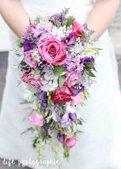 a bride holding a bouquet of flowers in her hands