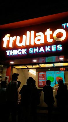 people are standing in line at the fruhlato's thick shakers