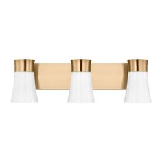 three light bathroom fixture with gold trim and white glass shades on the top, in an antique brass finish