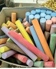 there are many different colored crayons in the bins and one is full of them