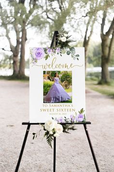 a welcome sign with flowers and greenery on it for a princess themed birthday party