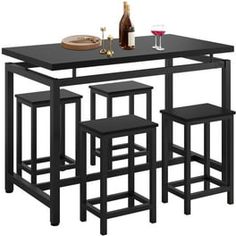 a black table with four stools and a wine bottle