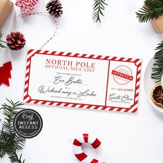 a red and white ticket sitting on top of a table next to some christmas decorations