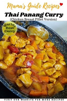 a pan filled with chicken and vegetables on top of a table next to a spoon