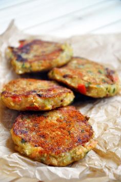 three crab cakes sitting on top of a piece of wax paper with the words save and pin