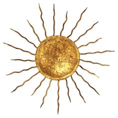 the sun is made out of gold and has long, thin branches on it's sides