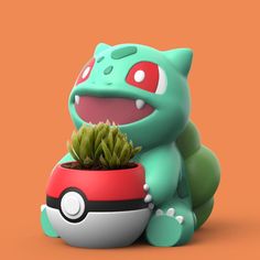 a green and red toy sitting next to a potted plant on an orange background