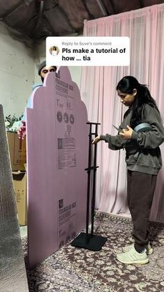 a woman standing in front of a purple screen with an instagram message on it