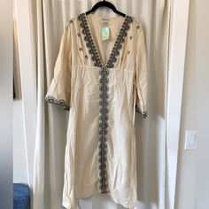 This Gorgeous Tunic Can Be Yours Just In Time For Summer. Ivory With Black Embroidery, Slightly Flared Sleeves, And Tie At The Waist. Forever 21 V-neck Beach Maxi Dress, Beige Floral Embroidered Maxi Dress For Beach, Embroidered Cream Kaftan For Summer, Spring Vacation Cream Kaftan, Cream Kaftan For Spring Vacation, Cream Embroidered Kaftan For Summer, Forever 21 Bohemian Dress For Vacation, Bohemian Vacation Dress By Forever 21, Forever 21 V-neck Dress For Vacation