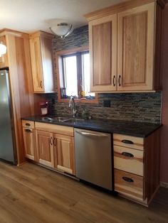 a kitchen with wooden cabinets and stainless steel appliances