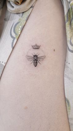 a bee with a crown tattoo on its back