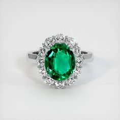 The ring features a beautiful, transparent 2.91 carat oval shape green emerald with the dimensions of 11.10 x 9.33 x 4.77 mm and a mixed brilliant cut. It has a clarity grade of eye clean (evaluated at eye level), vivid color saturation, and an excellent polish. #engagementrings #lovering #promiserings #cuterings #engagementringideas Classic Green Halo Ring With Brilliant Cut, Classic Green Brilliant Cut Halo Ring, Oval Emerald Ring With Halo Design, Formal Gia Certified Green Halo Ring, Classic Green Emerald Ring With Halo, Gia Certified Oval Emerald Halo Ring, Green Oval Halo Ring For Formal Occasions, Green Oval Halo Ring For Anniversary, Formal Green Oval Halo Ring