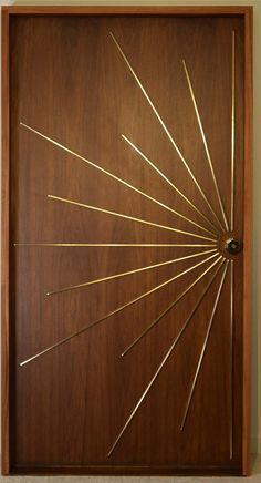 a wooden door with gold sticks sticking out of it's center and the top part of its frame