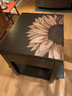 a coffee table with a sunflower painted on it