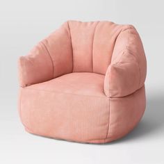 a pink chair sitting on top of a white floor