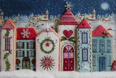 a group of houses with christmas decorations on the front and side, all painted in different colors