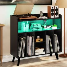 a record player is sitting on top of a shelf with records and other music equipment