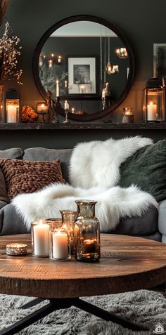 a living room filled with lots of furniture and candles on top of a wooden table