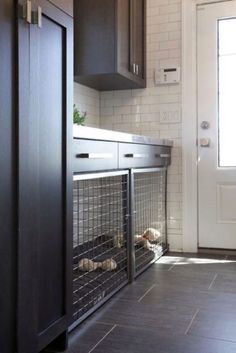 a dog cage in the corner of a kitchen