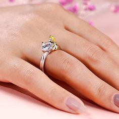 Wearing a beautiful yellow gold dress, our little princess elegantly holds a glistening stone and sedately sits on the shank. Every girl dreams to be a princess, who lives in a fancy castle, owns countless dolls & dresses, and is doted by all her family and friends. You may not be a princess, but you can have this ring to show your femininity and superior temperament. The ring is crafted in precious sterling silver, with amazing details on the face, dress, and hair of the princess. It definitely makes a perfect gift for your beloved one. Carat Weight: 2.5 ctStone Size: 7 mmStone Type: Jeulia® StoneNumber of Stones: 1 Stone Shape: RoundStone Color: Diamond WhiteCarat Weight: 0.3 ctStone Size: 0.8 mmStone Type: Jeulia® StoneNumber of Stones: 2 Stone Shape: RoundStone Color: Fancy BlackMateri Yellow Round Cut Diamond Ring Gift, Princess Style Cubic Zirconia Wedding Jewelry, Yellow Princess Cut Jewelry Gift, Yellow Princess Cut Jewelry For Gifts, Fancy Castle, Innocent Beauty, Yellow Gold Dress, Hug Me, Girls Dream