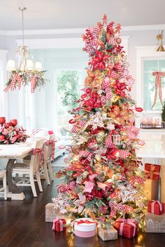 a christmas tree decorated with candy canes and bows