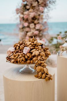 almonds are piled on top of each other in front of the ocean and flowers