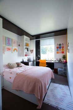 a bedroom with a bed, desk and shelves in the corner on either side of the room