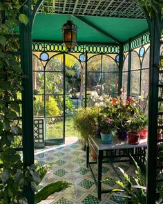 the inside of a green house with lots of potted plants