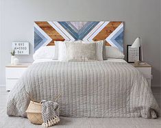 a bedroom with a bed, nightstands and pictures on the wall above it is decorated in pastel colors