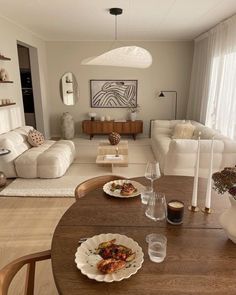 a living room filled with furniture and a wooden table