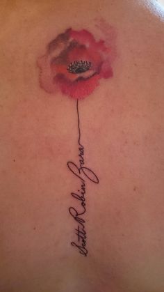 the back of a woman's neck with a rose and her name written in cursive writing