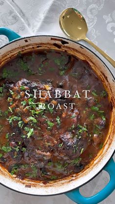 a pot filled with meat and garnish on top of a table