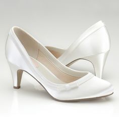 a pair of white high heeled shoes on a white background with the bottom part showing