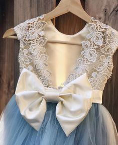 a blue and white dress with a large bow