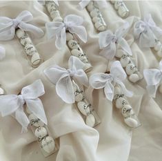 wedding favors are wrapped in white satin ribbons