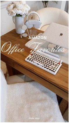 an old fashioned typewriter sitting on top of a wooden desk next to a vase with flowers